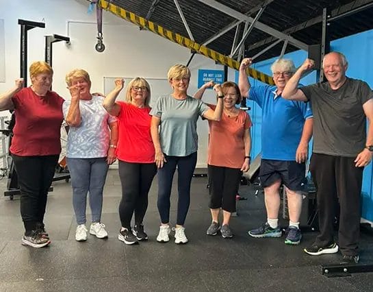 MaxFit Gym Over 55s Group of People Flexing